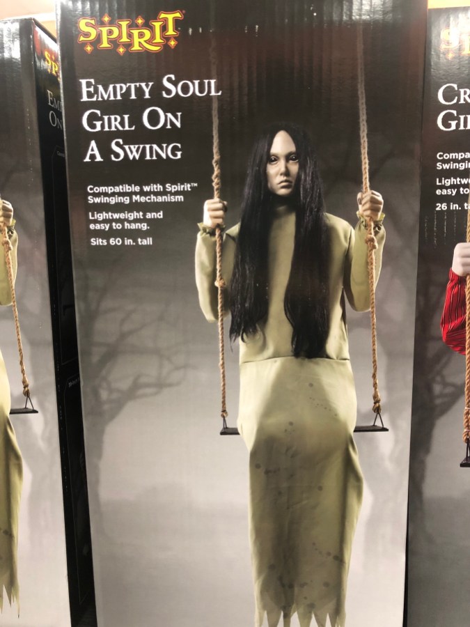 a box labeled Empty Soul Girl Sitting on a Swing with a halloween prop of a creepy girl sitting on a swing