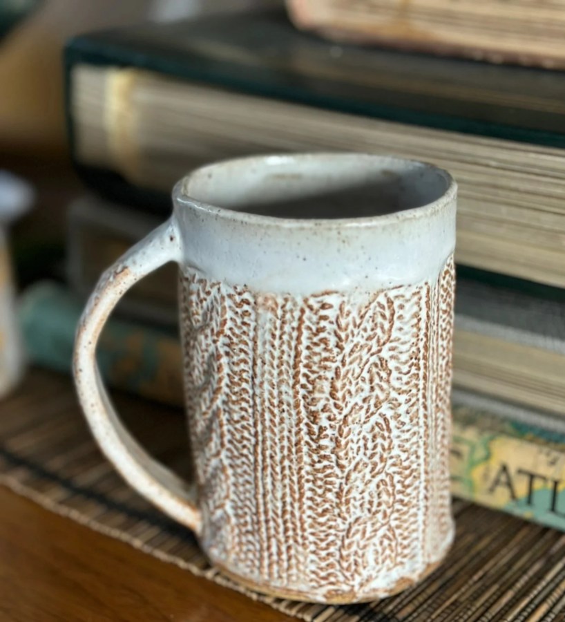 a ceramic mug with a cableknit pattern