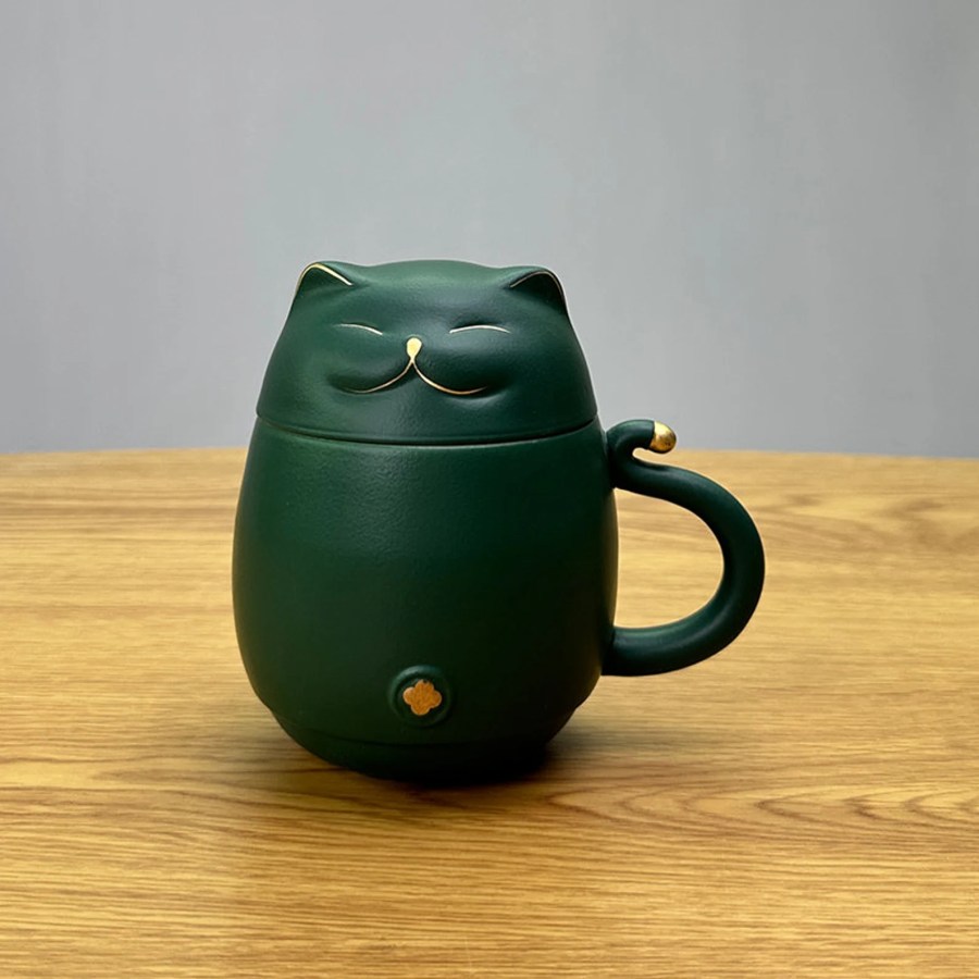 a dark green ceramic mug shaped like a cat
