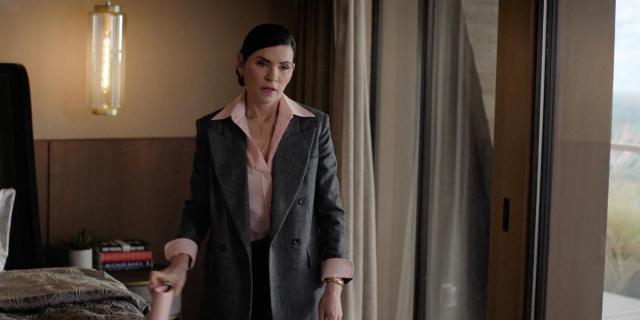 Julianna Margulies wearing a wide collar pink blouse and oversized gray blazer, looking disappointed on The Morning Show 304