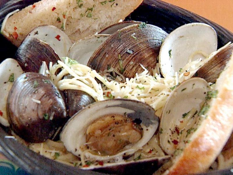 a pot of clams in buttery garlic sauce