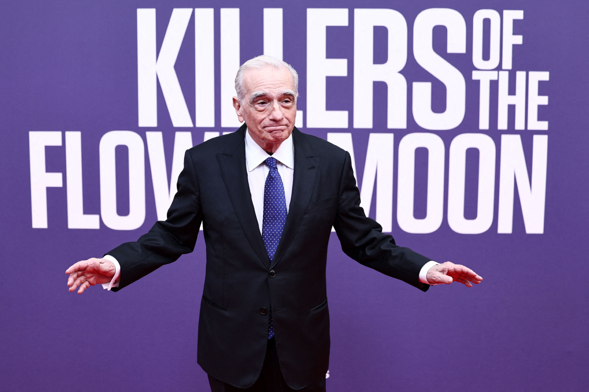 Martin Scorsese lifts his arms up on the red carpet for the London Film Fest premiere of Killers of the Flower Moon.