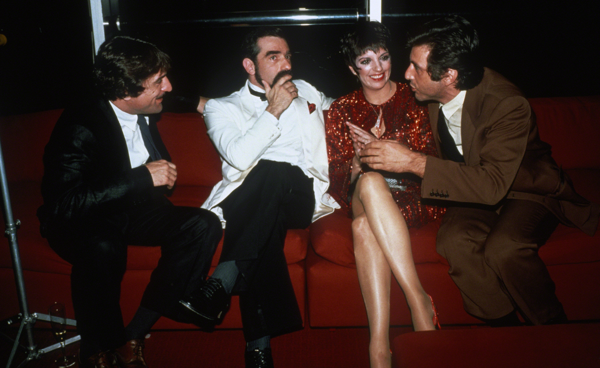 Scorsese sits on a couch between Robert De Niro, Liza Minelli, and Al Pacino.