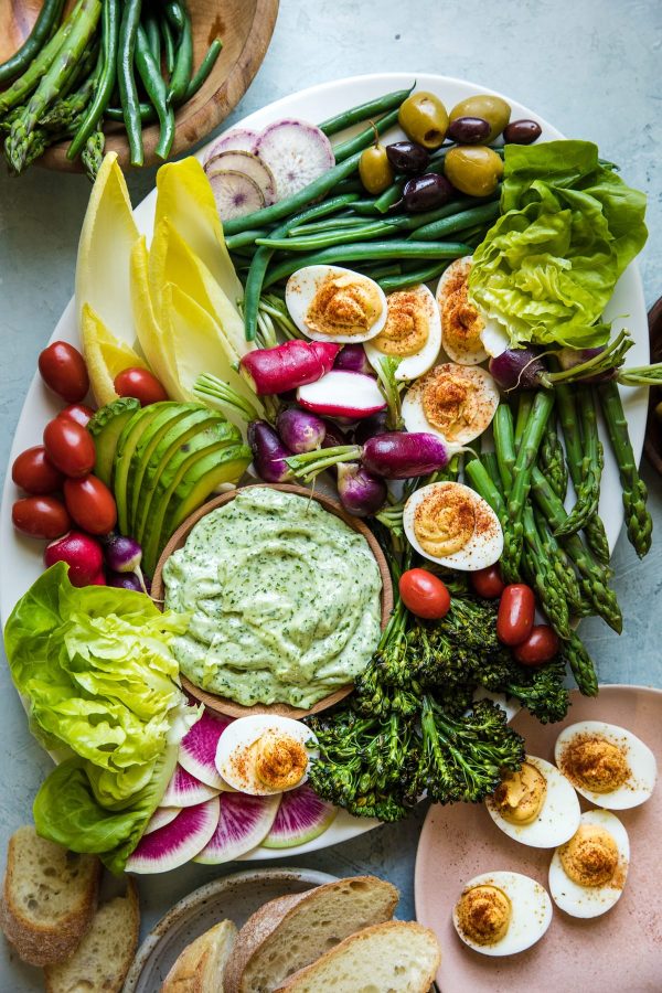 a plate of veggies and boiled eggs with a side of aioli