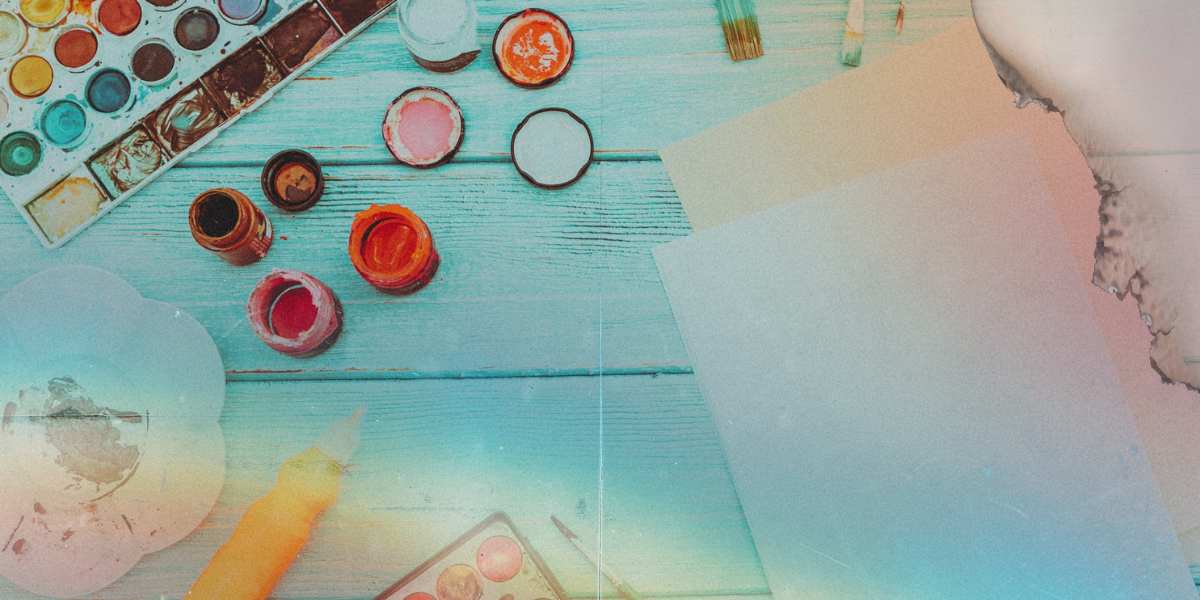 a photo of a setup of crafting supplies with overexposure rainbows layered on top of it