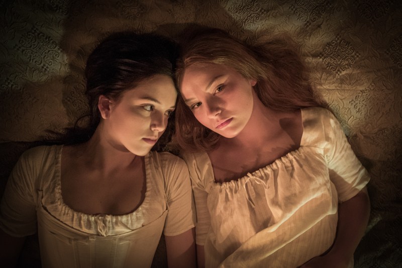 Carmilla and Laura snuggling in white nightgowns in Carmilla (2019)