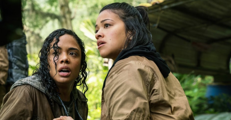 Tessa Thompson and Gina Rodriguez in the wilderness in Annihilation, looking in horror at something