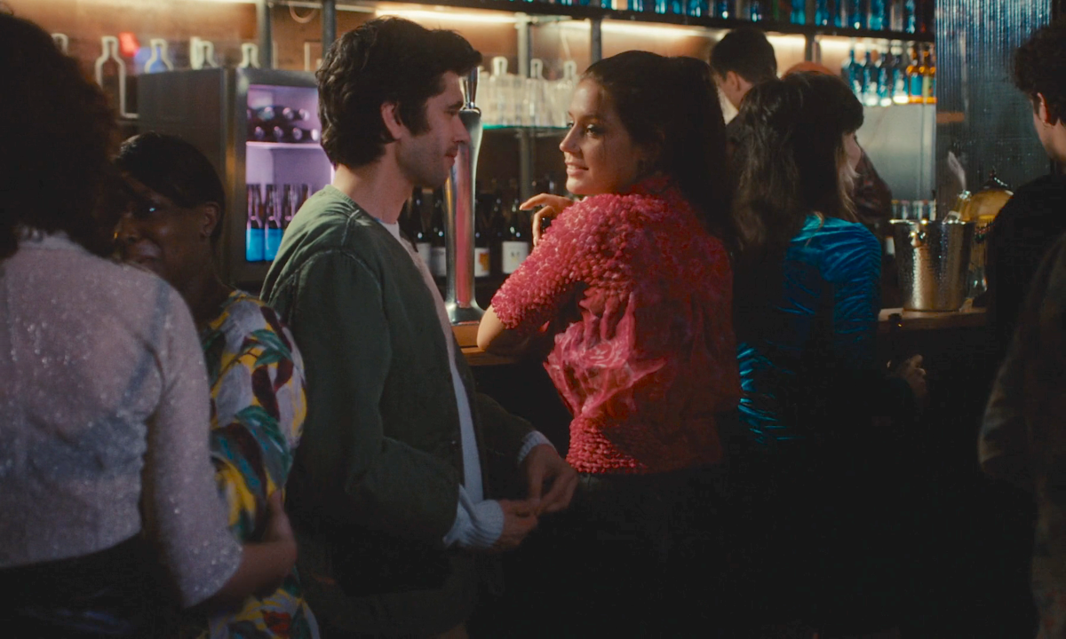 Clothes from Passages: Adèle Exarchopolous in a textured pink top talks to Ben Whishaw at a bar.