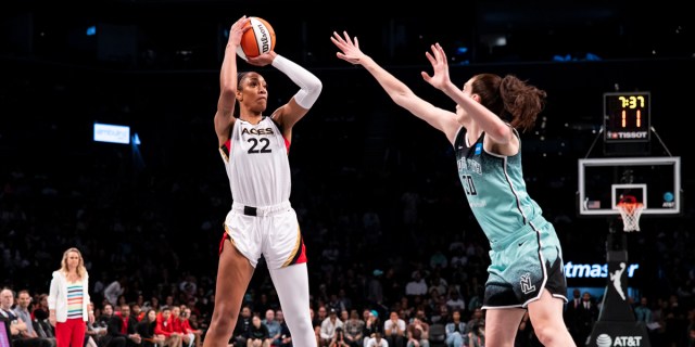 : A'ja Wilson #22 of the Las Vegas Aces make a shot against Breanna Stewart #30 of the New York Liberty at Barclays Center on August 28, 2023 in New York City.