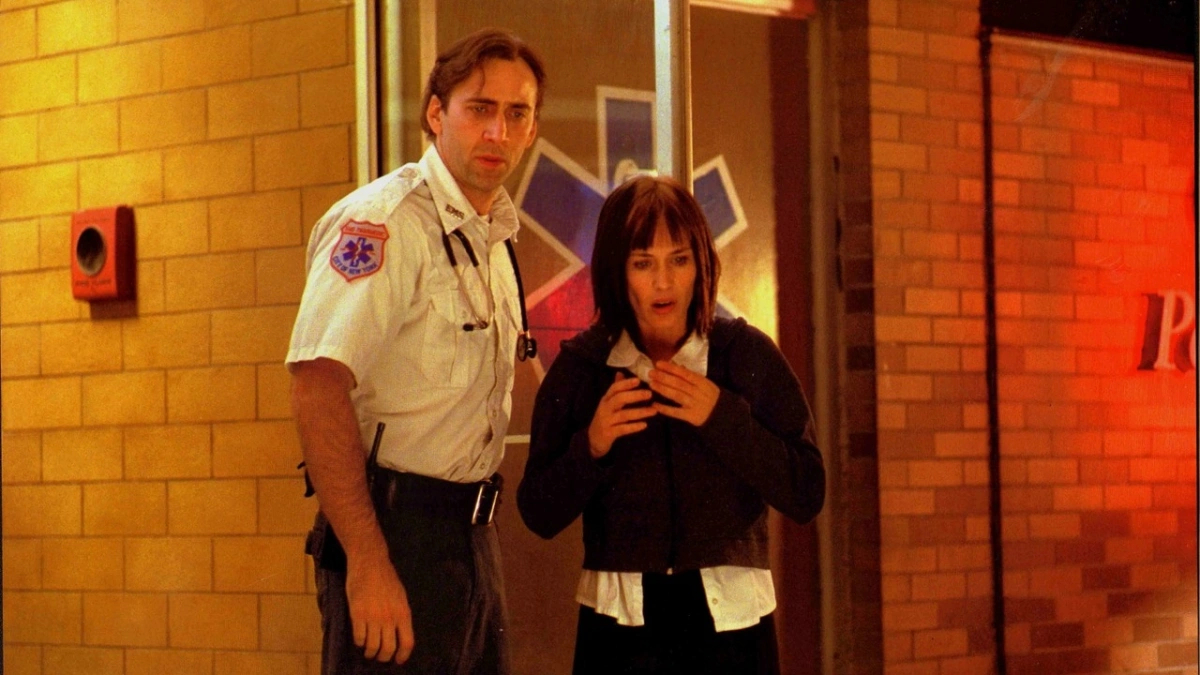 Nicolas Cage dresses as a paramedic stands next to Patricia Arquette as they both looked shocked.
