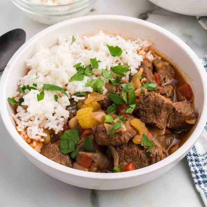 a bowl of garlicky beef stew with rice