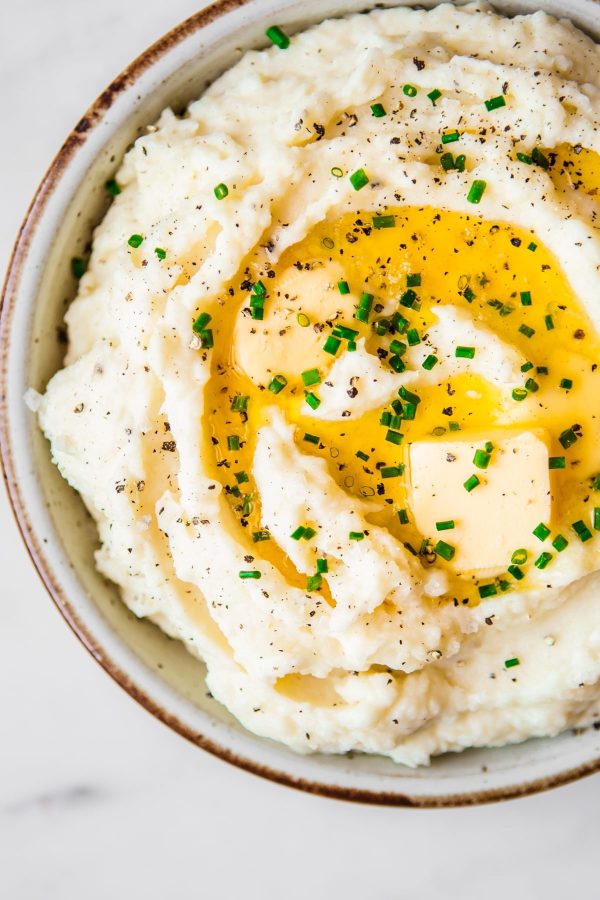 a bowl of mashed potatoes with a generous pour of oil