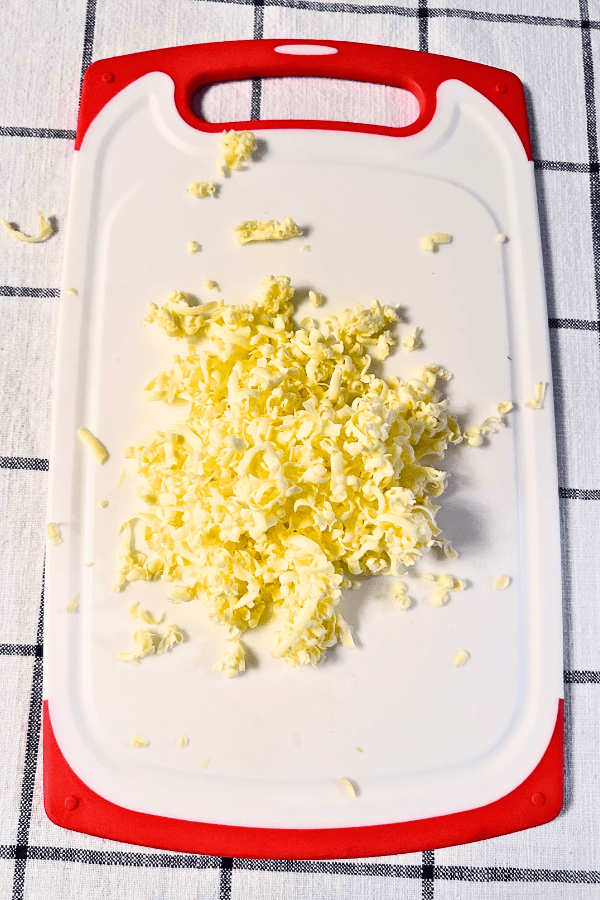 Grated butter piled on a cutting board