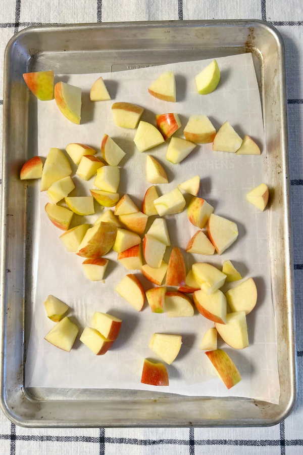 cut up apples, piled together on top of parchment paper