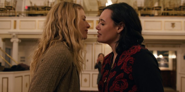 two women lean toward each other as if about to kiss