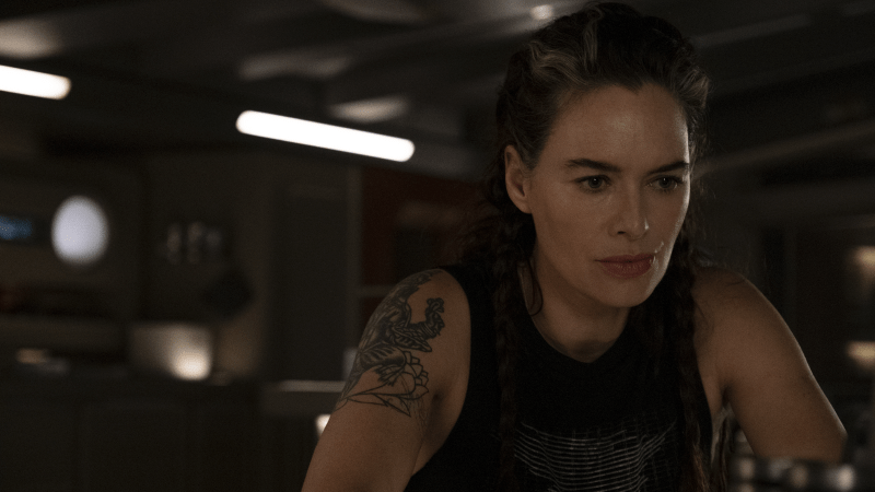Beacon 23 screenshot of Lena Headey's character Aster sitting in a black tank top, focused on something off screen