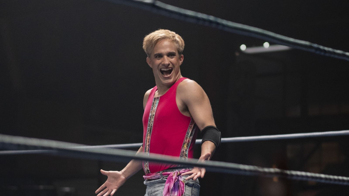 Queer sports movies: Gael Garcia Bernal smiles and shrugs in a wrestling ring in Cassandro