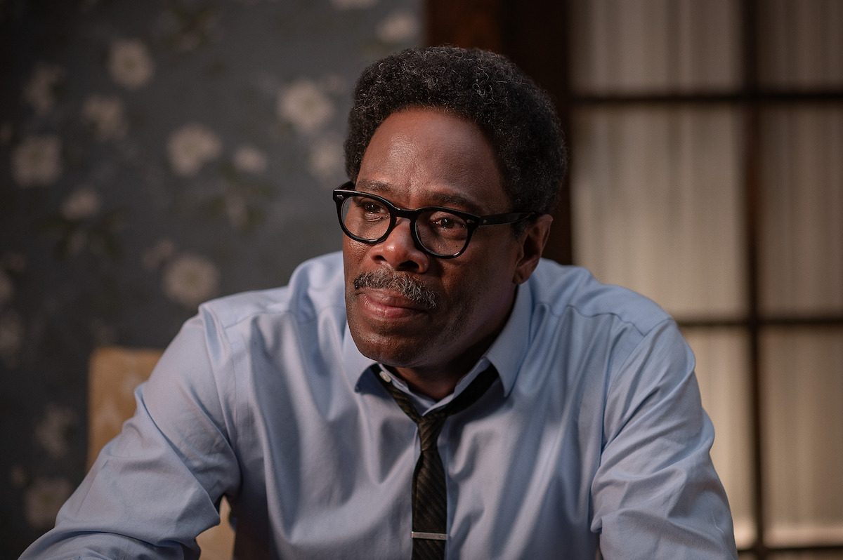 A close up of Colman Domingo as Bayard Rustin in a light blue button down shirt and a skinny brown tie