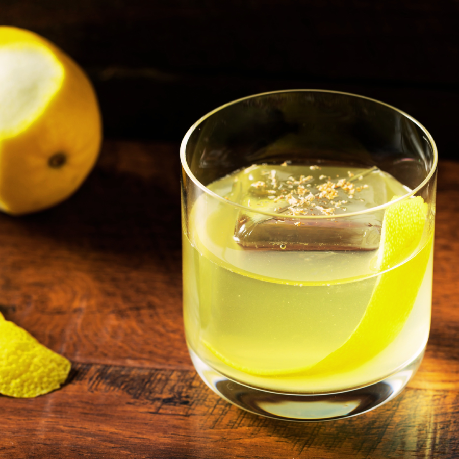 milk punch in a glass with a lemon peel