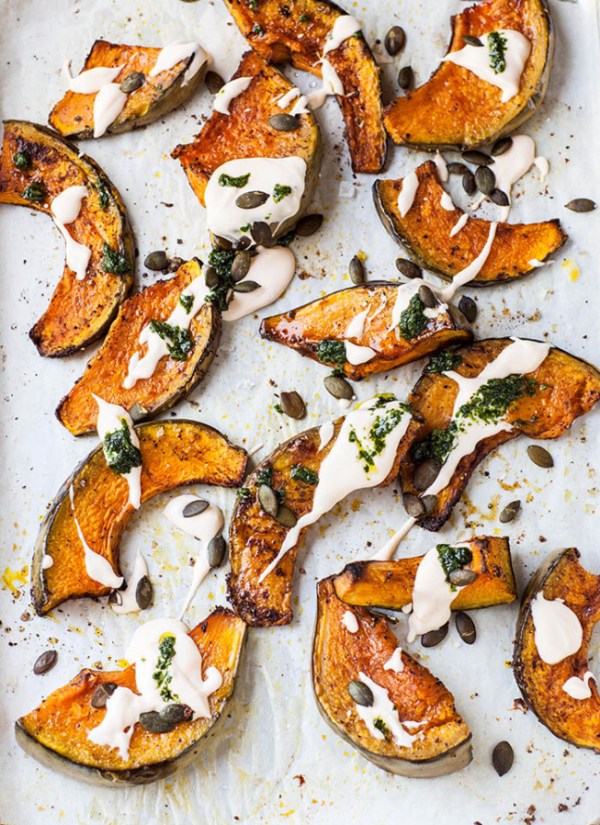 a pan of roasted pumpkin with a yogurt drizzle