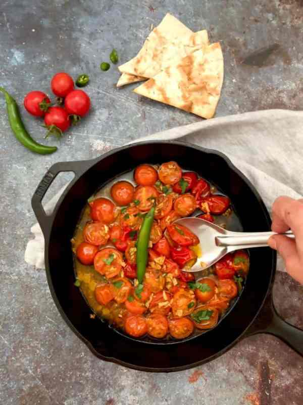 a cast iron pan of simmered tomatoes