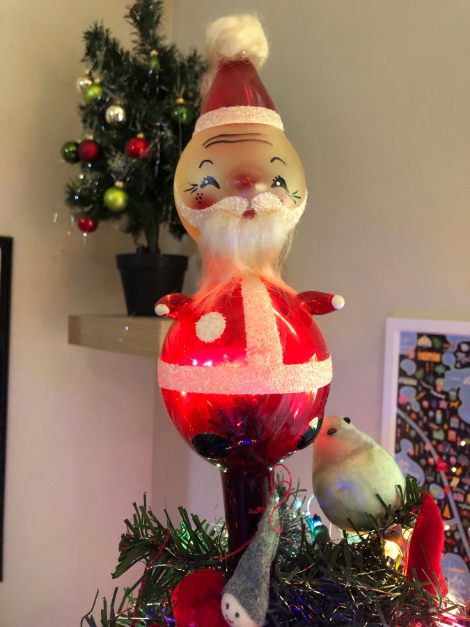 A glass Santa tree topper