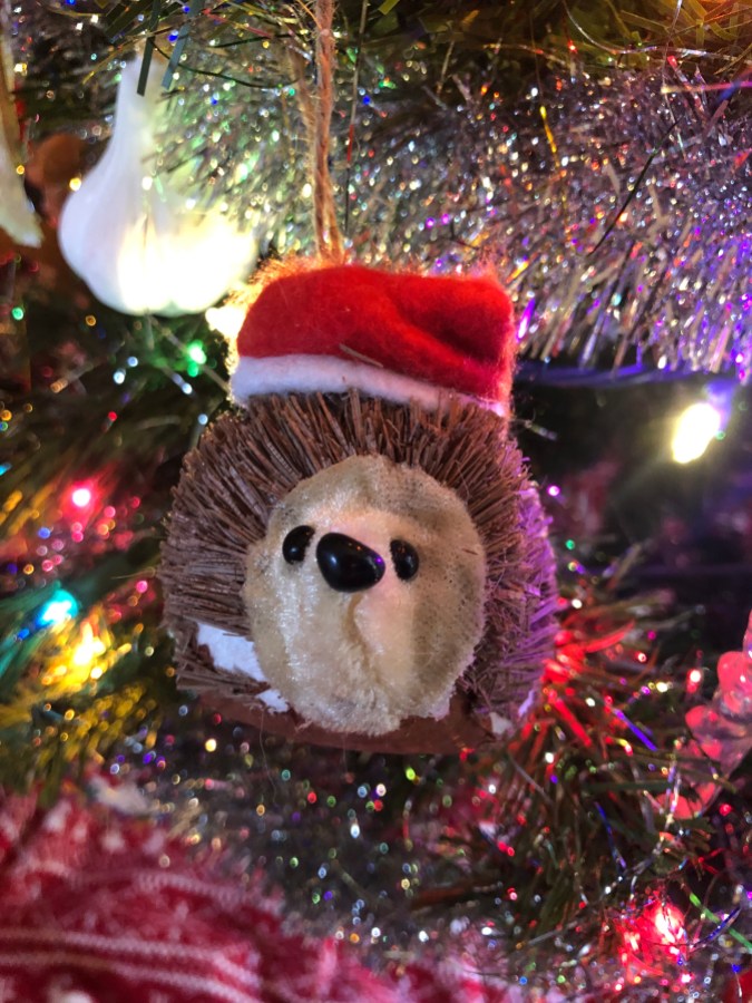 a hedgehog ornament with a santa hat