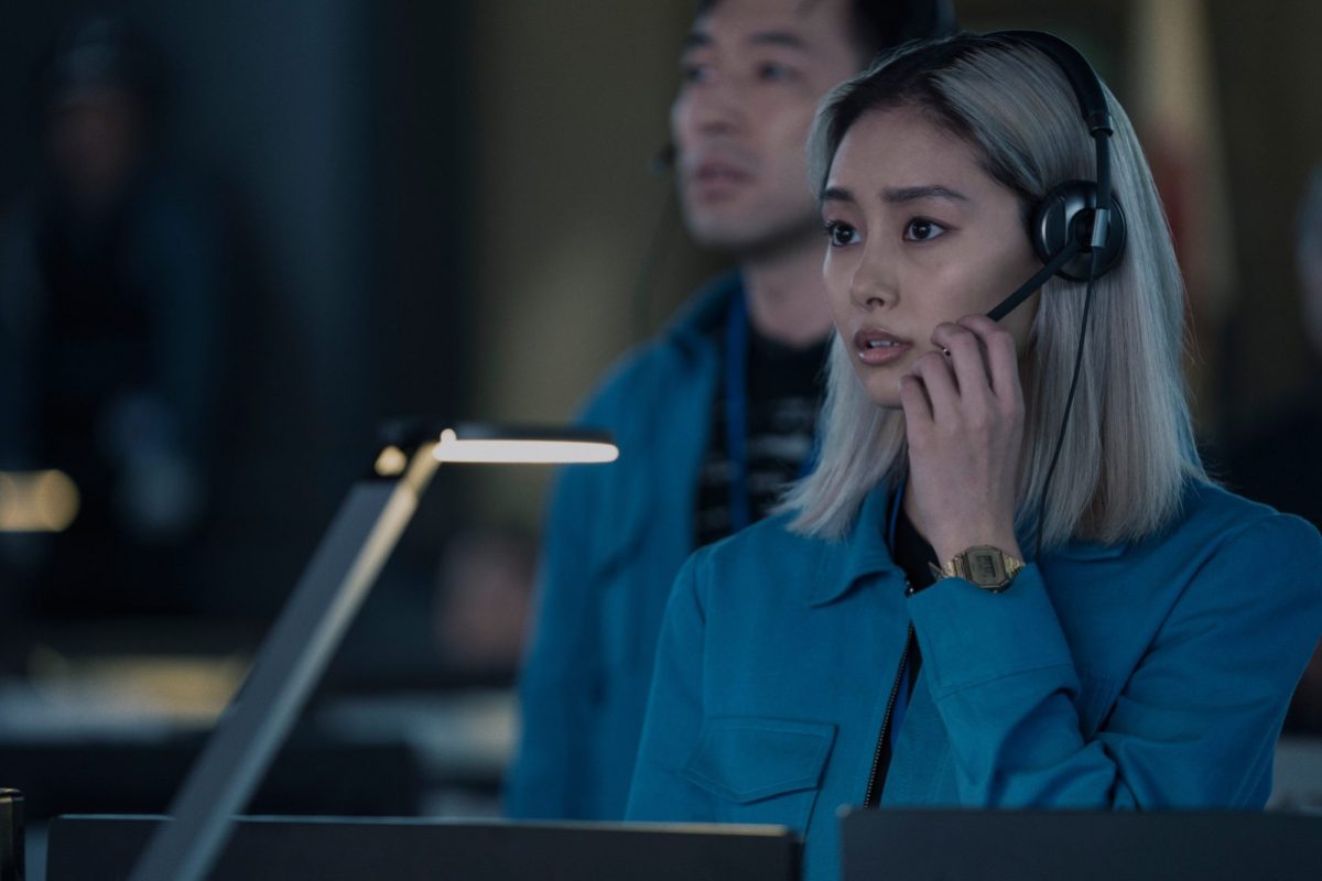 a space worker on her headset while a space launch is happening