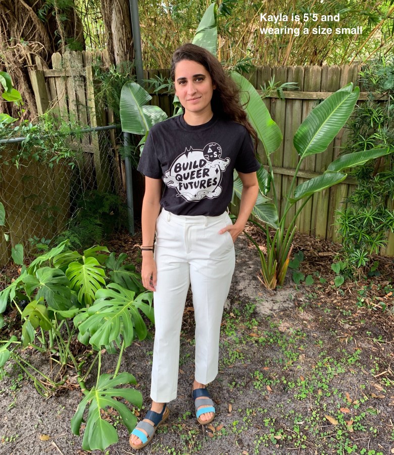 Kayla in a black "Build Queer Futures" t-shirt