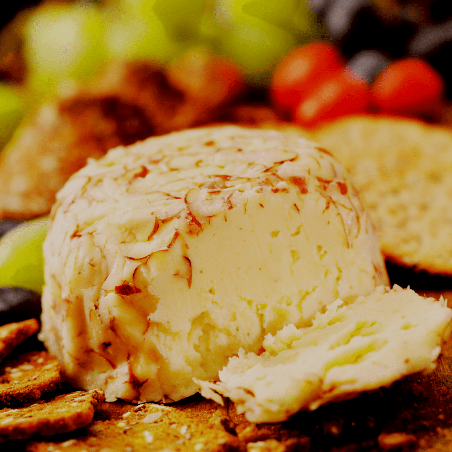 a close up of a cheese ball with nut crust