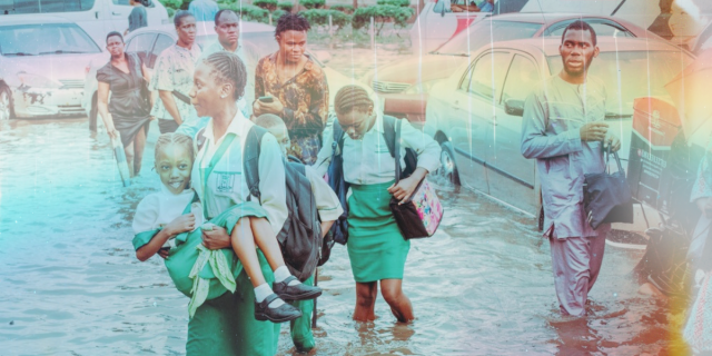 A young school girl is seen carrying anither school girl as they try to navigate a flooded road after school hours just after the rain in Lagos, West of Nigeria on October 6, 2022.
