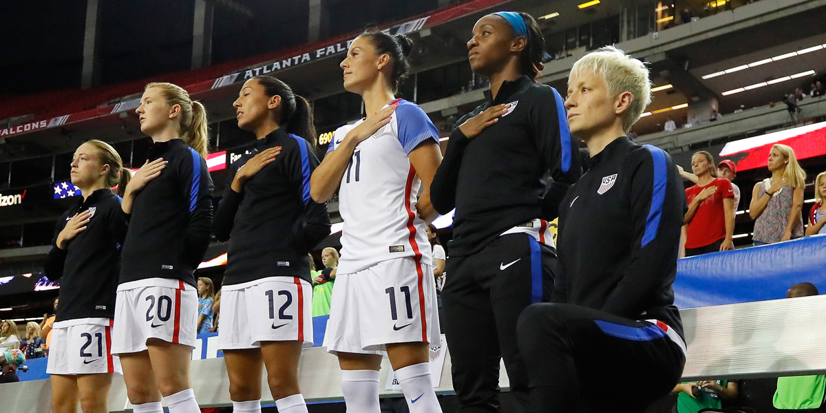 Megan Rapinoe #15 kneels during the National Anthem prior to the match between the United States and the Netherlands at Georgia Dome on September 18, 2016 in Atlanta, Georgia.