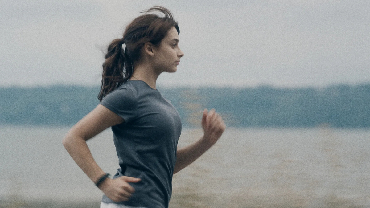 A side profile of a teen girl running.