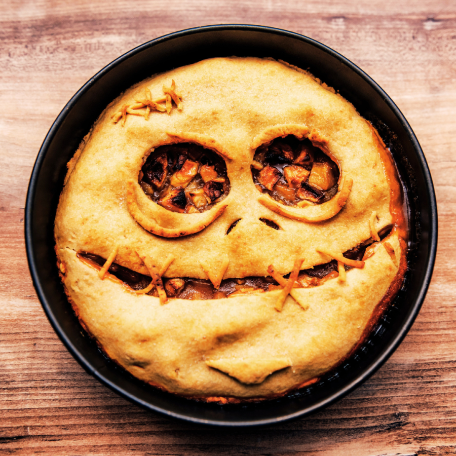 a pie where a scary face is carved into the top crust