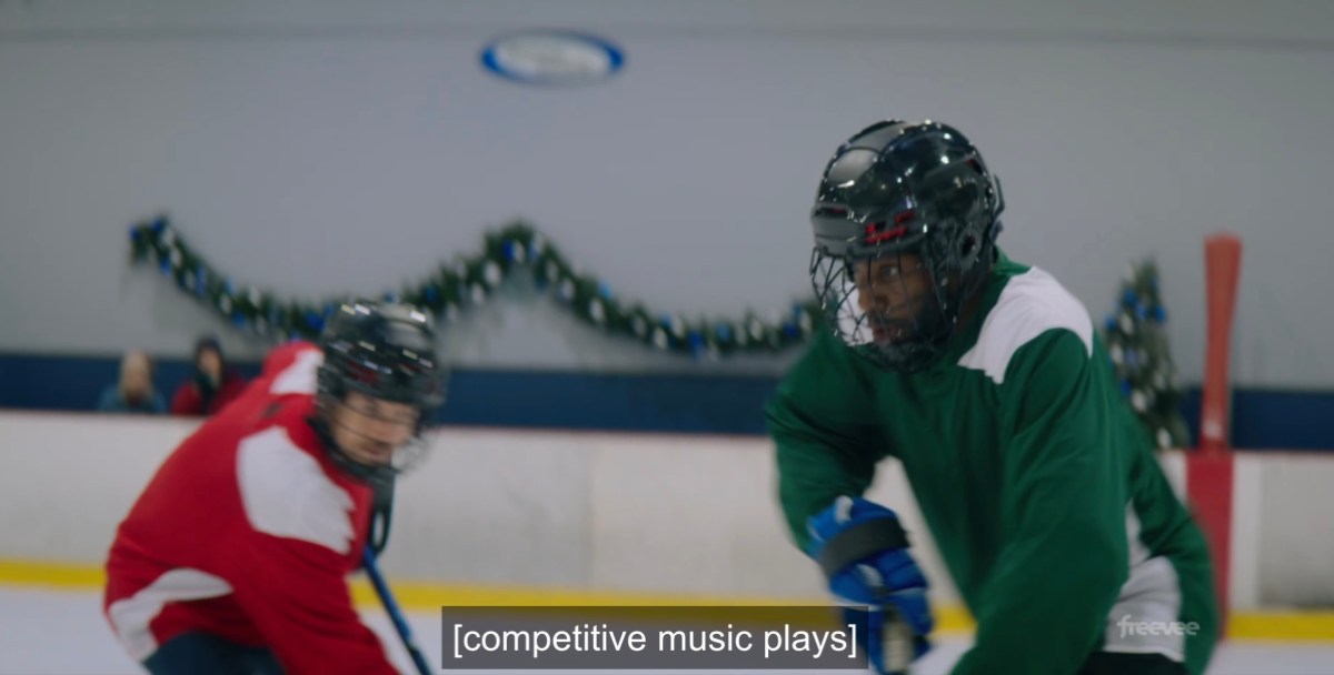 two men play hockey while "competitive music plays"