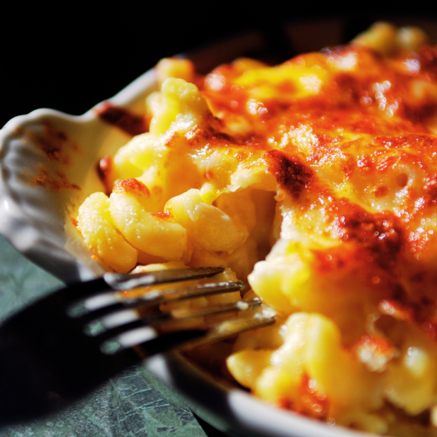 a close up of macaroni and cheese with a fork