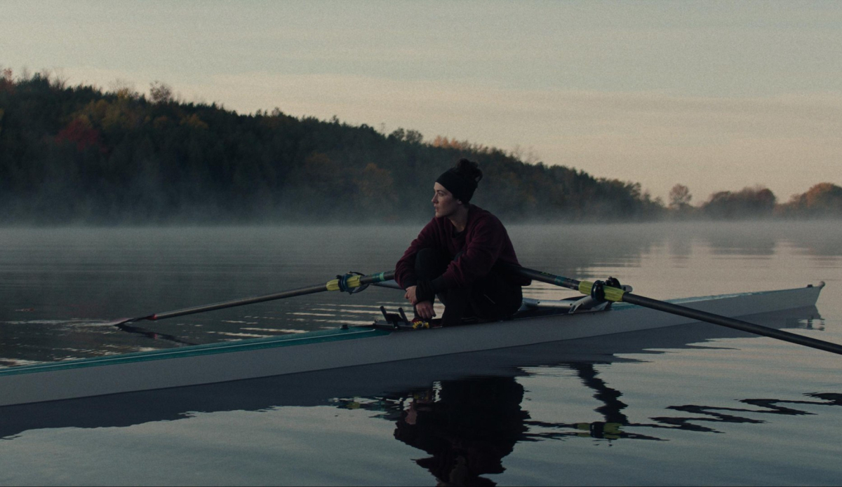 Isabelle Fuhrman sits in a boat by herself in the middle of a lake in The Novice.