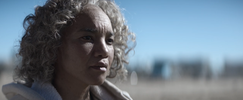 Black Cake: screenshot of present day eleanor bennett sitting and staring at the ocean