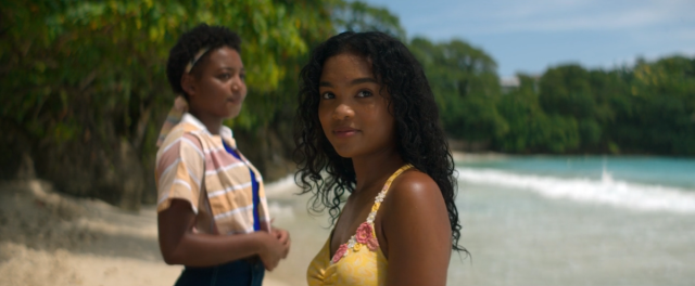 Screenshot of Bunny and Covey standing on a Jamaican beach and staring off into different directions