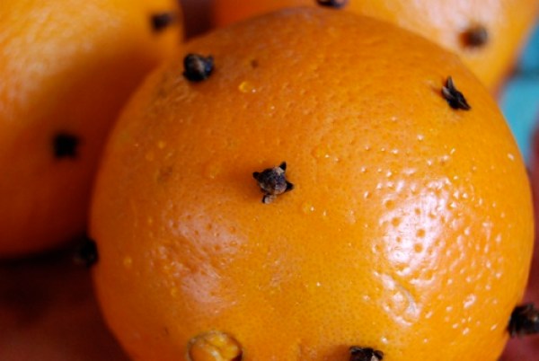 an orange with cloves in it