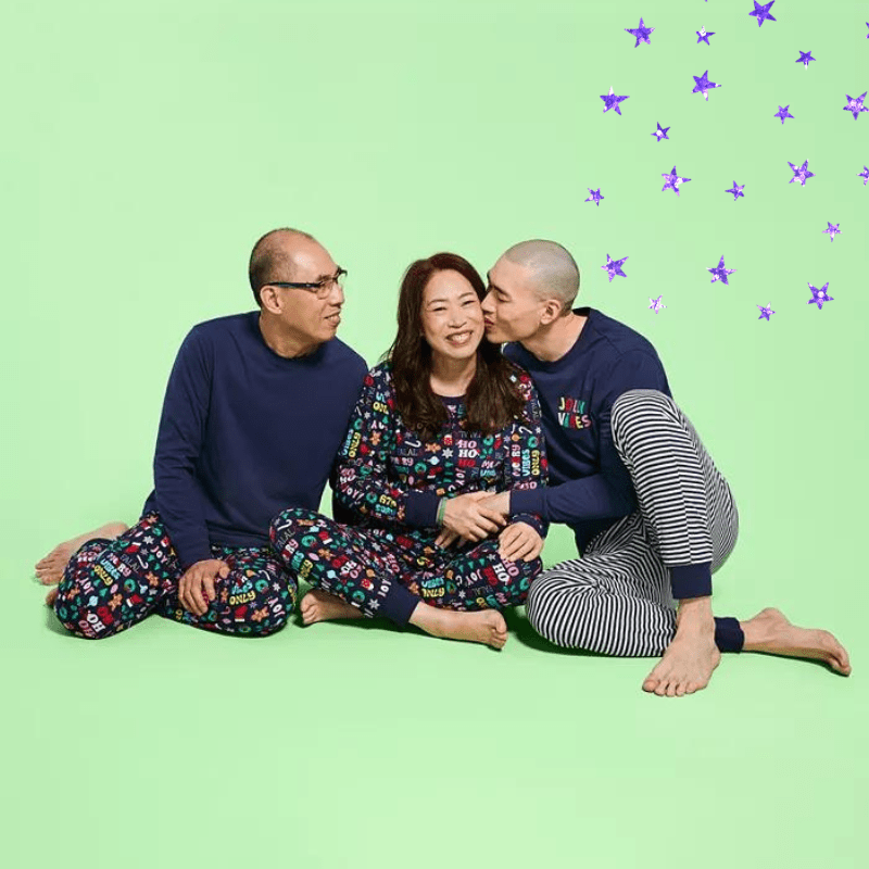 three adults in matching holiday pajama sets