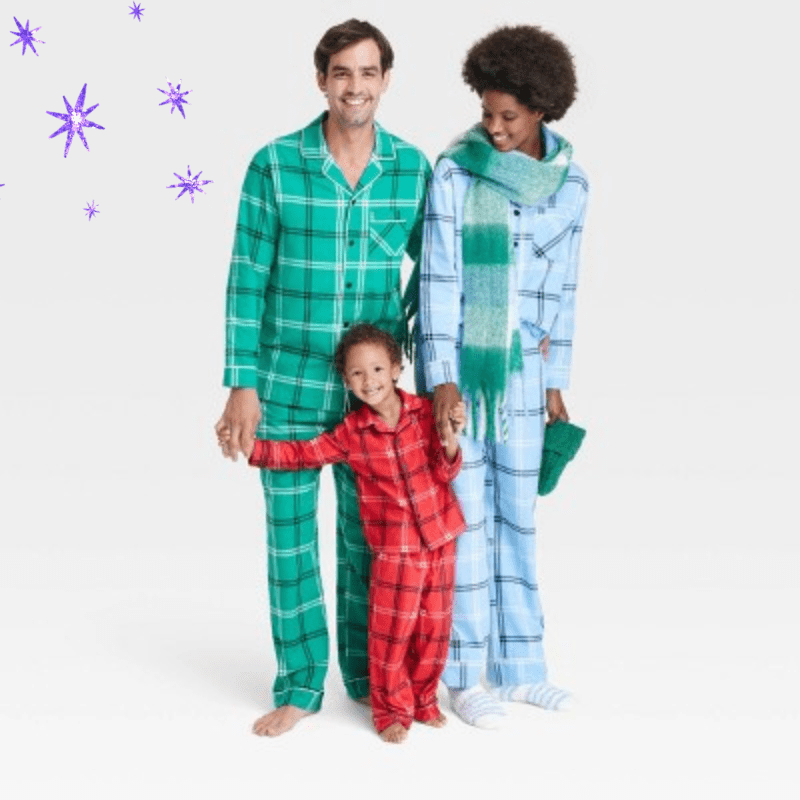two parents and a toddler in matching color blocked plaid pajama sets