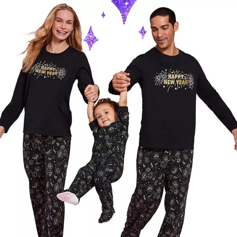 two parents and a baby in matching black New Year's Eve pajamas
