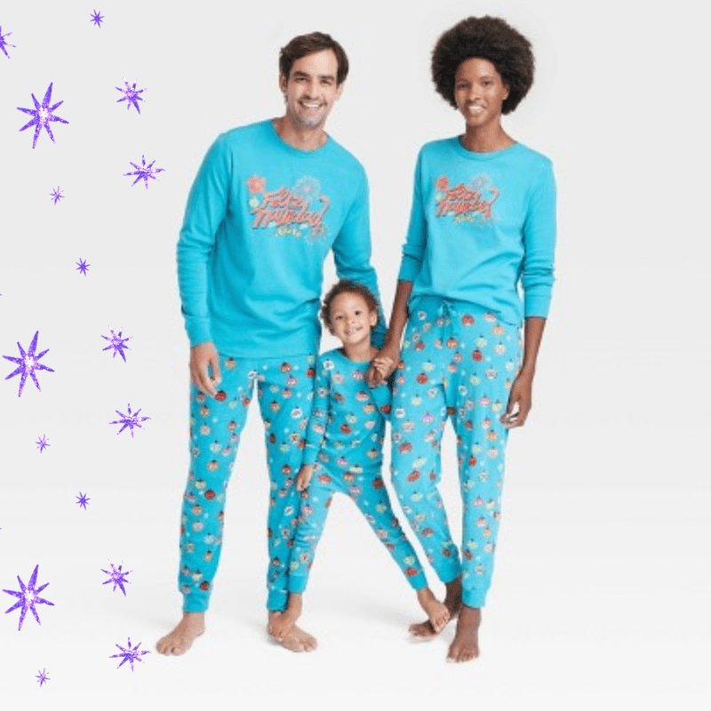 two parents and a toddler in matching Feliz Navidad pajamas