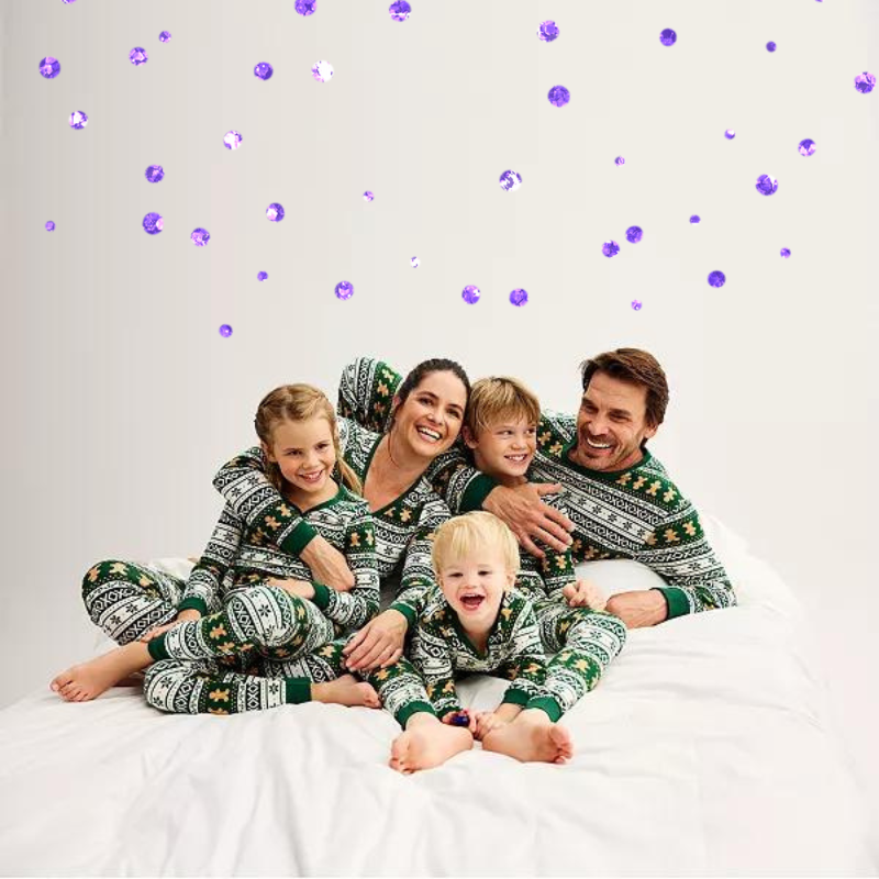 two parents and three kids in matching green holiday pajama sets