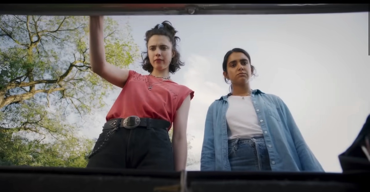 two lesbians looking into the trunk