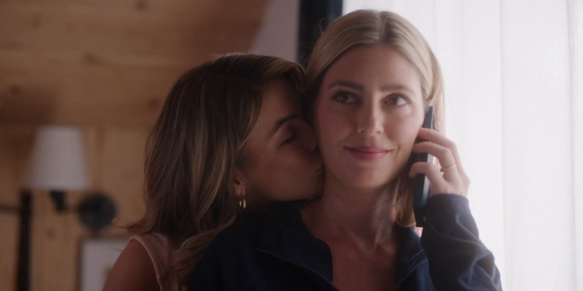 Chrishell Stause and Diora Baird in You're Not Supposed To Be Here. Chrishell is kissing her neck.