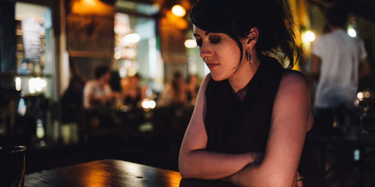 a woman alone at the bar