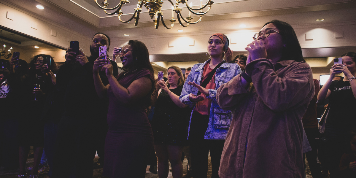 a group of people gather to watch election day results in Virginia