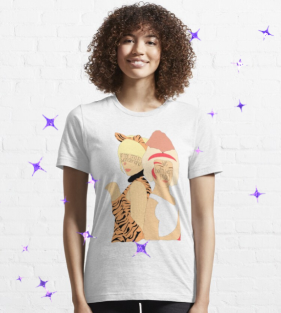 Model wearing a white t-shirt that has illustrations of two women, on their faces reads: in the era in wonderland, we both went mad